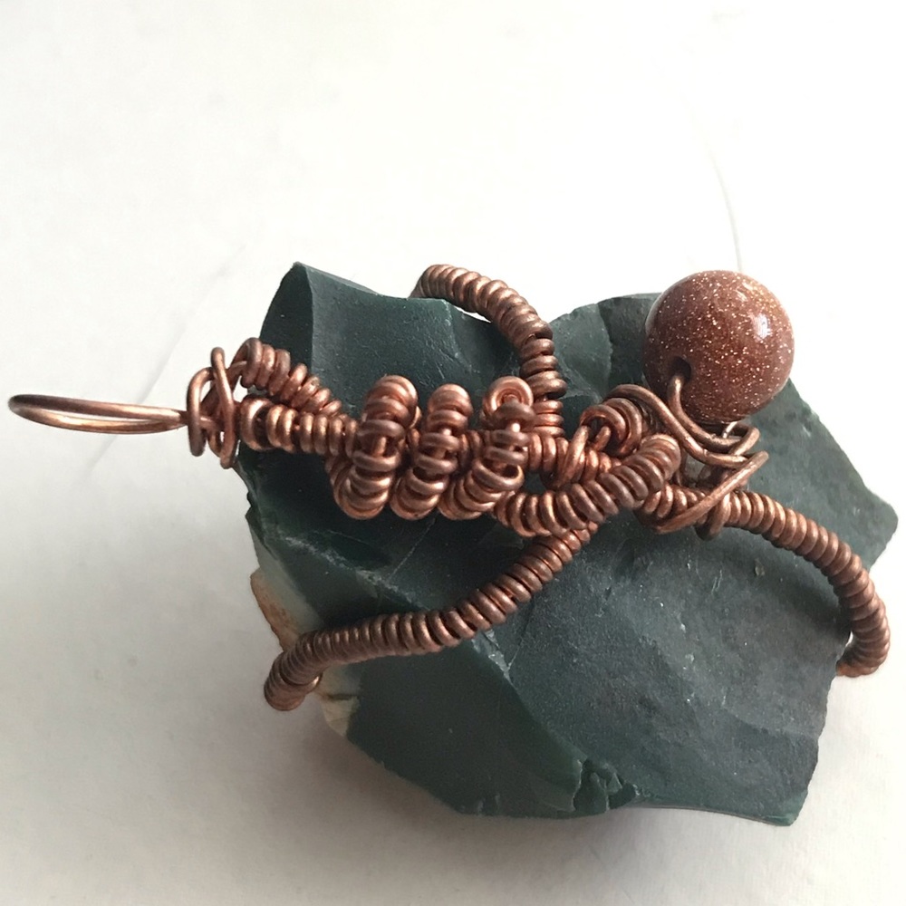 Wire wrapped green jasper with goldstone accent